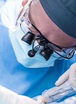 an oral surgeon performing dental implant surgery