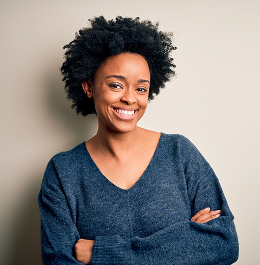 Woman smiling after visiting a dental office in Norwood