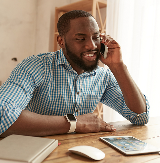 Man talking on the phone with a dental office in Norwood