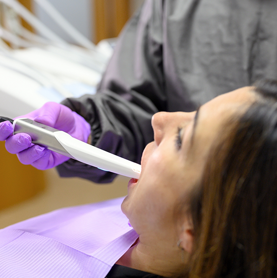 Dental patient getting her teeth digitally scanned