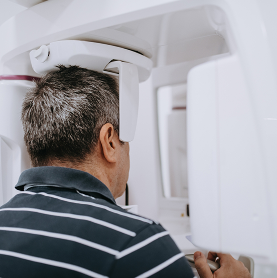 Dental patient getting a cone beam scan of his mouth and jaws