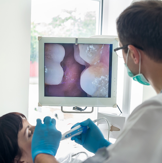 Dentist taking close up photos of a patient's teeth