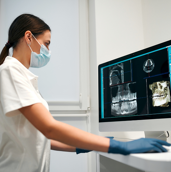 Dentist looking at x rays of a patient's teeth