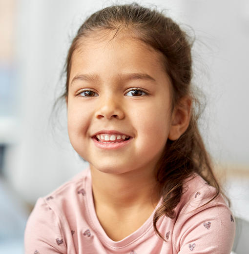 Young girl with long dark hair in a ponytail