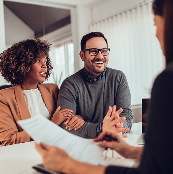Man and woman talking to someone across from them