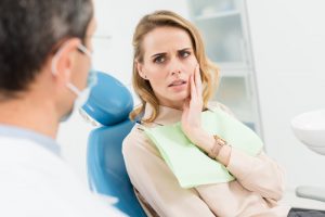 concerned woman dentist chair